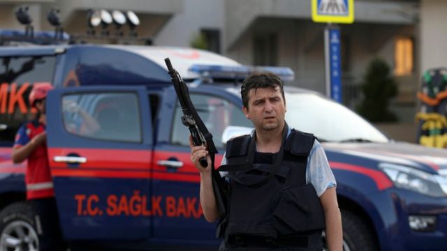 A plain clothes policeman holds a gun in Marmaris
