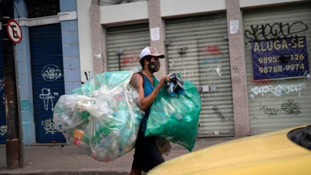 Waste picker wearing protective mask against covid-19