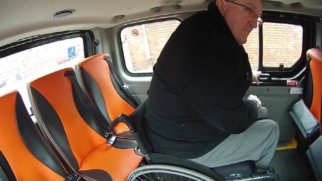 Dave Thompson in a wheelchair accessible taxi