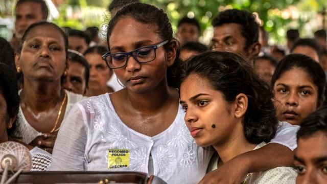 A woman cries as she holds her friend for comfort during a mass funeral at St Sebastian's Church on April 23, 2019 in Negombo, Sri Lanka