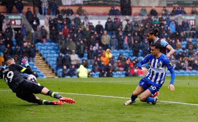 Arijanet Muric saves a shot from Brighton & Hove Albion's Facundo Buonanotte