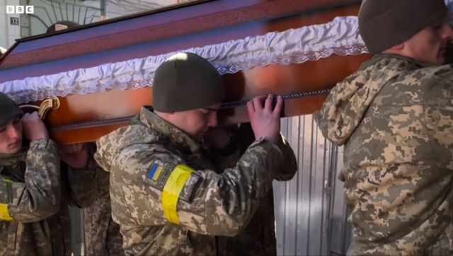 Ukrainian soldiers grieve.