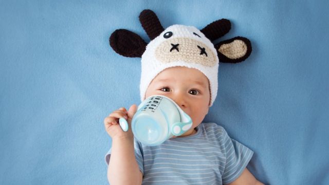 Baby drinking milk from a bottle.