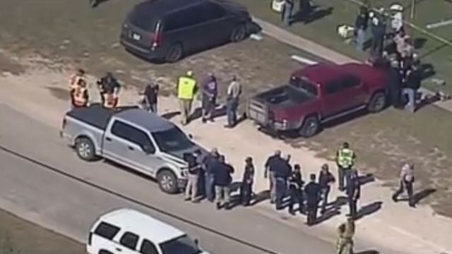 Aerial shot of people milling around scene of shooting