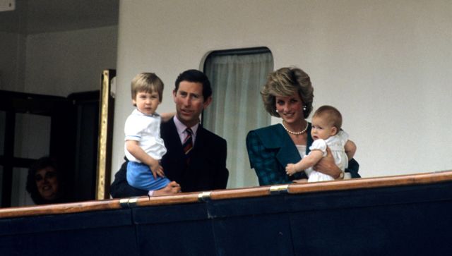 The couple with their children Prince William and Prince Harry looking out from the deck of the Royal Yacht Britannia on 5 May 1985 in Venice, Italy.