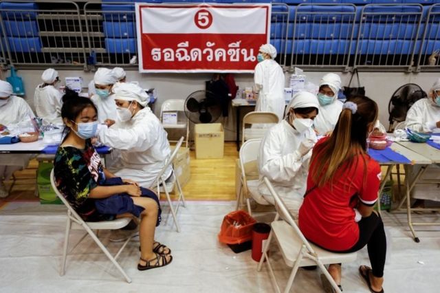 Women receive the Sinovac coronavirus disease (COVID-19) vaccine as the Thai resort island of Phuket rushes to vaccinate its population amid the COVID-19 outbreak ahead of a July 1 end of strict quarantine for overseas visitors to bring back tourism revenue, in Phuket