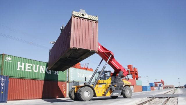 A shipping container is lifted at a rail port on August 18, 2018 in Erenhot, Inner Mongolia Autonomous Region of China.