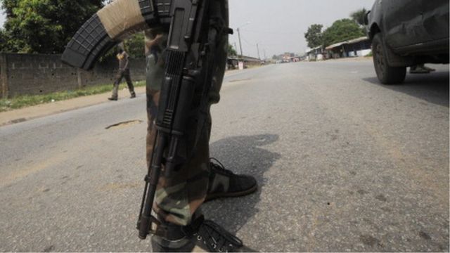 Close up of a soldier from Ivory Coast's Republican Forces as he stands guard near the paramilitary police barracks in the Yopougon district in the west of the city of Abidjan on December 21, 2012.