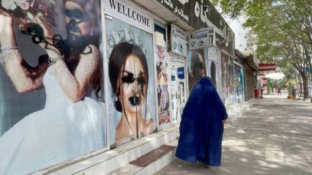 Posters of women on beauty salon windows are vandalised in Kabul, Afghanistan on 20 August 2021.