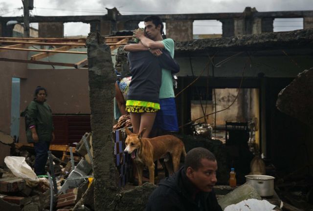 Residentes de Baracoa, Cuba, observan los daños causados por las lluvias y las penetraciones del mar.