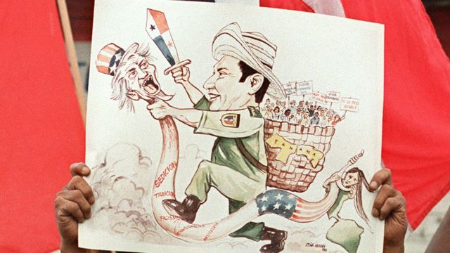 Pancarta con la caricatura de Manuel Noriega golpeando al Tío Sam.