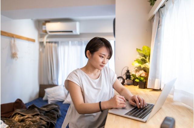 Young woman working at home in the morning - stock photo