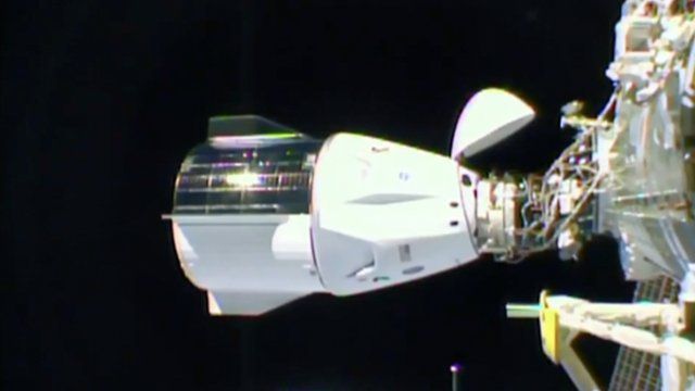 The Dragon capsule docked at 04:01 GMT as the station flew over the US state of Idaho