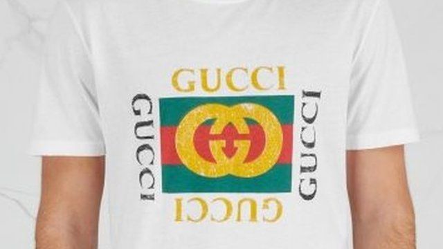 close up of Gucci branding on "fake Gucci" T-shirt