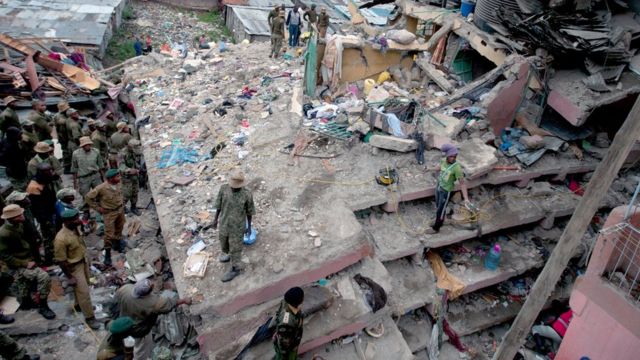 Kenyan police officers and Kenyan National Youth Servicemen work at the site of a building collapse in Nairobi, Kenya, Saturday, April 30, 2016