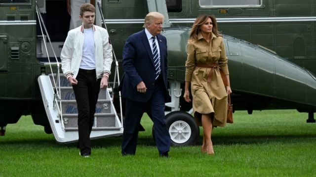 Barron Trump, Donald Trump and Melania Trump exit a helicopter