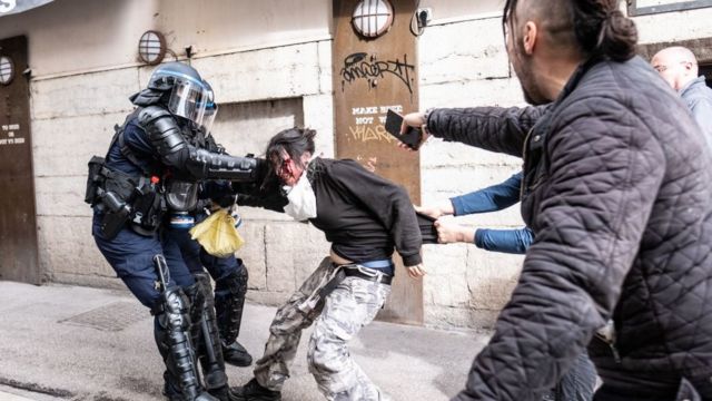 French police arrest a protester in the capital, Paris