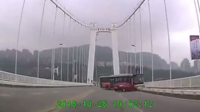 Security footage from another vehicle shows the bus hitting the security barriers