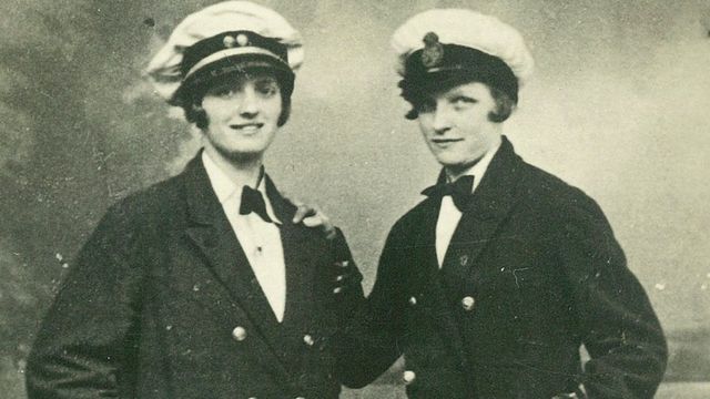 Two women dressed as Navy officers