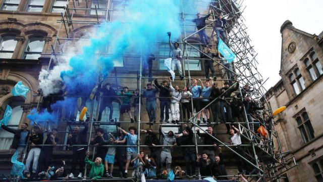 A general view as fans of Manchester City are seen using smoke flares whilst on scaffolding