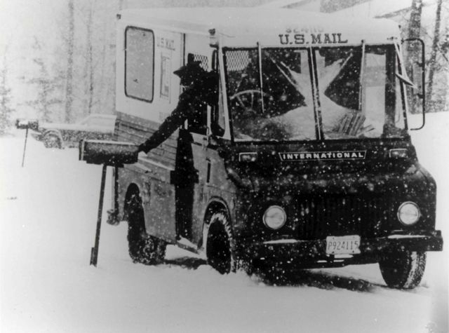 Carteiro deposita correspondência em caixa de correio em meio a nevasca (1954)