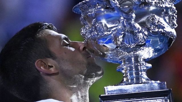 Novak Djokovic kisses the Australian Open trophy