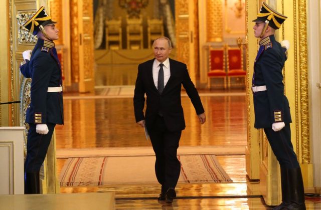 Russian President Vladimir Putin enters the hall during the reception marking the Day of Heroes of the Fatherland at Grand Kremlin Palace in Moscow, 11 December 2019