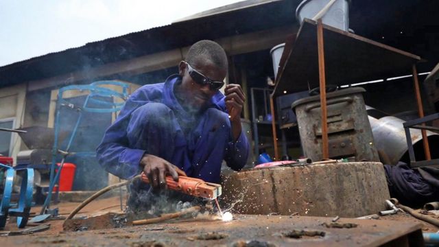 A Finic engineer builds a machine part in Sierra Leone