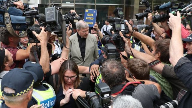Pell is surrounded by media as he left court on Tuesday after a reporting ban on his conviction was lifted