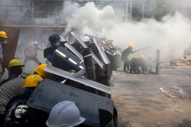 Protesters wear shields in Yangon.