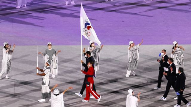 The flag bearers of the Russian Olympic Committee (ROC) Sofya Velikaya and Maxim Mikhaylov enter the stadium during the Opening Ceremony of the Tokyo 2020 Olympic Games at the Olympic Stadium in Tokyo, Japan, 23 July 2021.