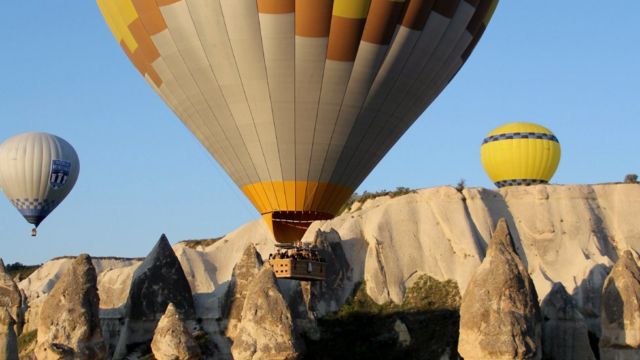Tourist balloons over the valley's phallic formations