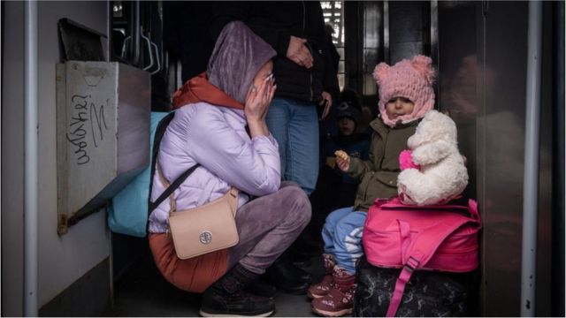 People board a train to leave the country at the railway station of the western Ukrainian city of Lviv on March 7, 2022, as Russian attacks continue