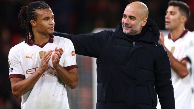 Pep Guardiola, Manager of Manchester City, embraces Nathan Ake
