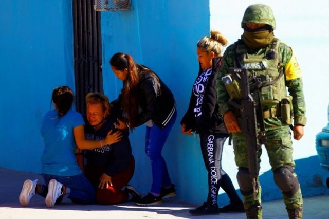Relatives react near a crime scene where unknown assailants attacked a wake in Ciudad Juarez. Photo: 12 February 2022
