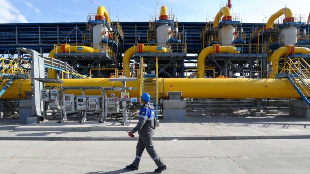 Un trabajador camina a través de una estación de filtro de salida hacia una planta de procesamiento de gas en el punto de partida del gasoducto de gas natural en alta mar Nord Stream 2.