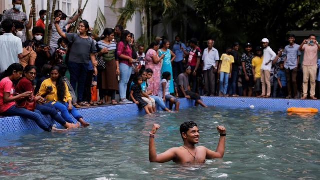 Un hombre en la piscina de la casa presidencial un día después de que los manifestantes ingresaran al edificio.