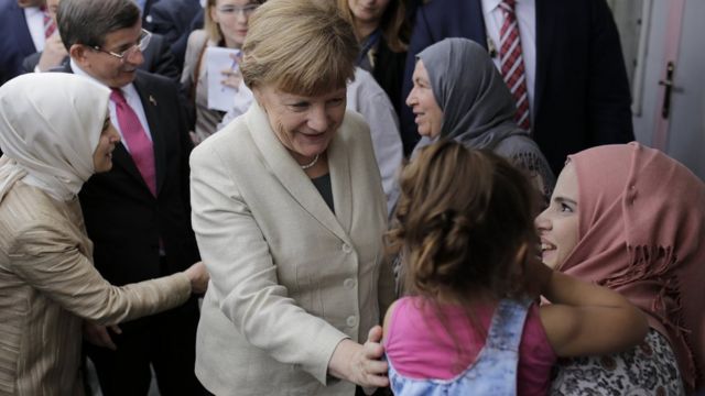 Chancellor Angela Merkel (centre) meeting refugees at a camp in Turkey, 23 Apr 16