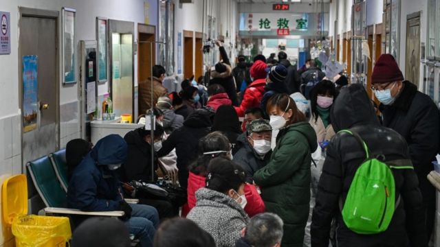 People wearing facemasks to help stop the spread of a deadly virus which began in the city, wait for medical attention at Wuhan Red Cross Hospital in Wuhan on January 25, 2020.