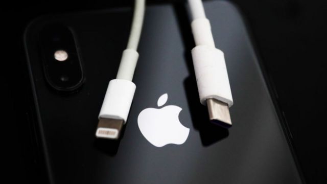 USB-C to lightning iPhone charging cable draped over iPhone