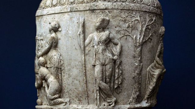 A marble jar dating back to the second or third decade BC, bearing a drawing of Artemis, carrying a torch representing her being the goddess of the night, and a quiver representing her being the goddess of hunting, and behind her is a pine tree.