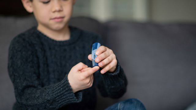 boy with glucometer