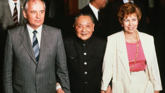 China's head of state, Deng Xiaoping (center), holds the hands of Mikhail and Raisa Gorbachev during a visit by the Soviet leader to China. (Photo by Peter Turnley/Getty Images)