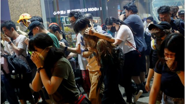 Anti-extradition bill protesters react after the police fired tear gas to disperse the demonstration at Sham Shui Po, in Hong Kong, China August 14, 2019.