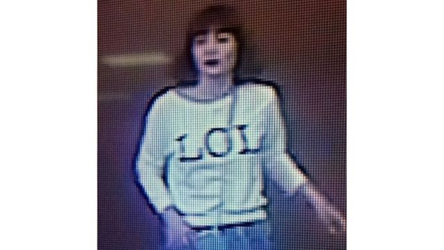 Grainy image shows a woman with brown hair wearing a T-shirt with the letters "LOL" emblazoned on it