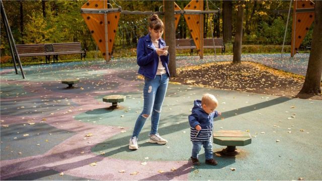 Mother in a playground with her son.