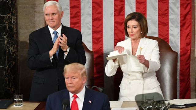 US Vice President Mike Pence claps as Speaker of the US House of Representatives Nancy Pelosi rips a copy of US President Donald Trump speech