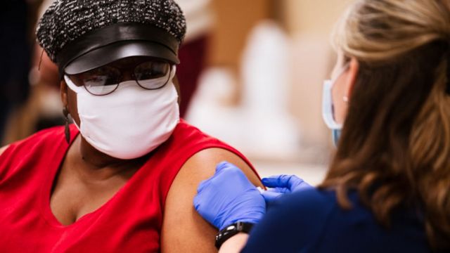 A woman gets a vaccine against the Corona virus