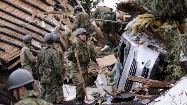 Rescue workers in the town of Atsuma