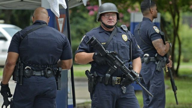 Baton Rouge Police stand at a checkpoint at the entrance of Our Lady Of The Lake Medical Center, Sunday, 17 July 2016, in Baton Rouge,